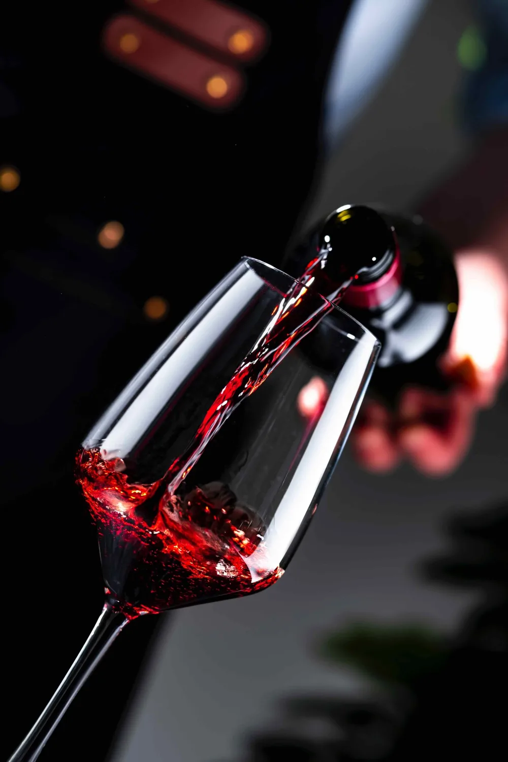 Red wine poured into a glass at the table
